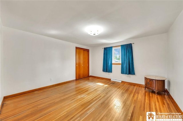 20 Post Rd, Amherst, NY 14221 - spare room featuring light wood-type flooring, a baseboard radiator, and baseboards