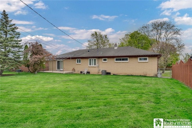 20 Post Rd, Amherst, NY 14221 - rear view of house featuring cooling unit, a patio area, brick siding, and a chimney