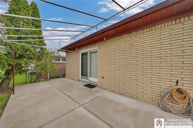 20 Post Rd, Amherst, NY 14221 - view of side of home featuring brick siding, fence, and a patio