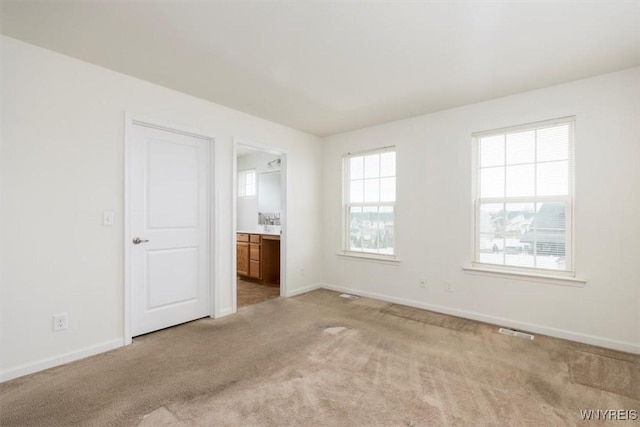 694 Pleasant View Dr, Lancaster, NY 14086 - unfurnished bedroom featuring light colored carpet, baseboards, and ensuite bathroom