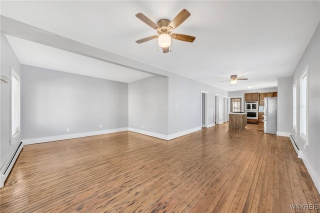 111 Roesch Ave, Buffalo, NY 14207 - unfurnished living room featuring ceiling fan, hardwood / wood-style floors, and a baseboard radiator
