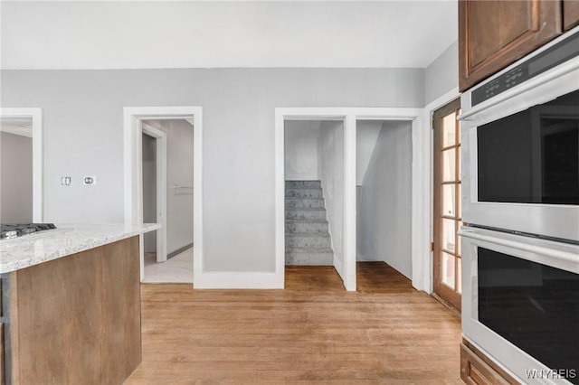 111 Roesch Ave, Buffalo, NY 14207 - unfurnished living room featuring light wood finished floors and stairs