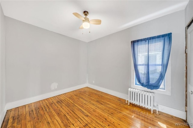 111 Roesch Ave, Buffalo, NY 14207 - empty room featuring radiator, a ceiling fan, wood-type flooring, and baseboards