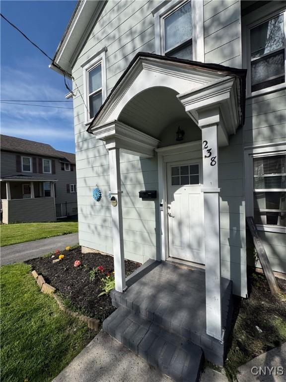 entrance to property with a yard