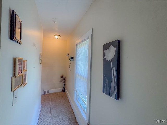 hall featuring baseboards