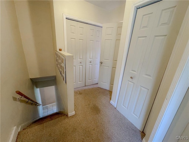 hallway with light colored carpet