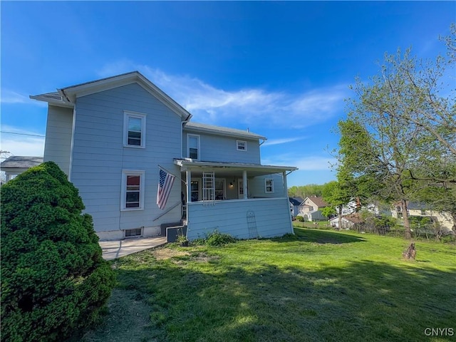 back of house with a lawn and central AC unit