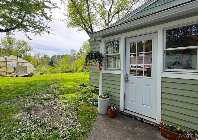 entrance to property with a lawn