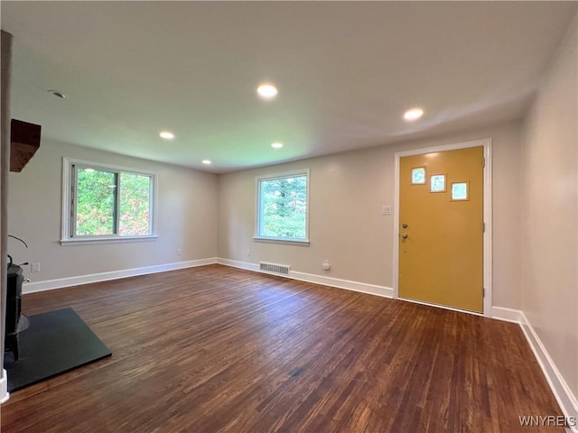 unfurnished living room with dark wood-style floors, baseboards, and recessed lighting