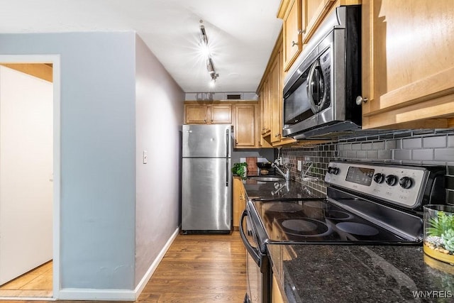 849 Delaware Ave Unit 305, Buffalo, NY 14209 - kitchen featuring appliances with stainless steel finishes, decorative backsplash, a sink, and dark stone counters