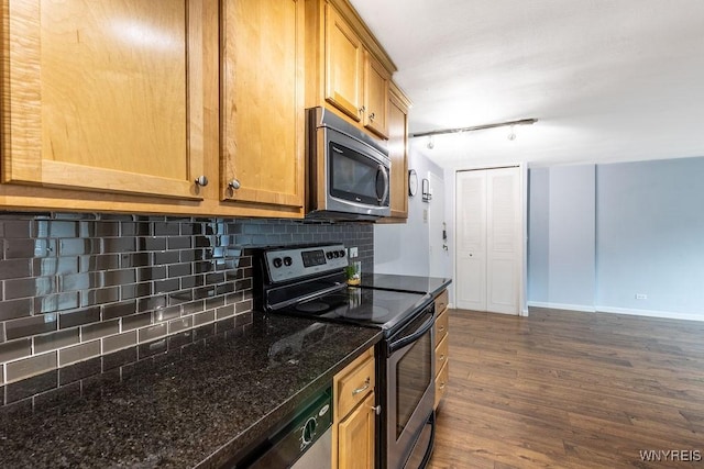 849 Delaware Ave Unit 305, Buffalo, NY 14209 - kitchen with appliances with stainless steel finishes, dark wood-type flooring, decorative backsplash, dark stone countertops, and rail lighting
