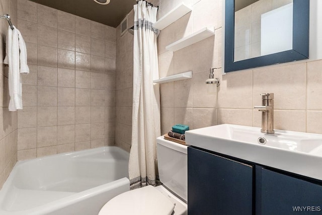849 Delaware Ave Unit 305, Buffalo, NY 14209 - bathroom featuring tile walls, toilet, shower / tub combo with curtain, vanity, and decorative backsplash
