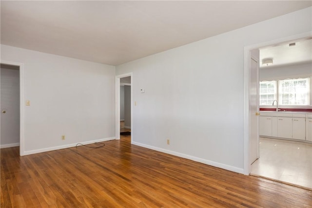 71 Dalrymple Ave, Southport, NY 14871 - spare room featuring light wood-type flooring, a sink, and baseboards