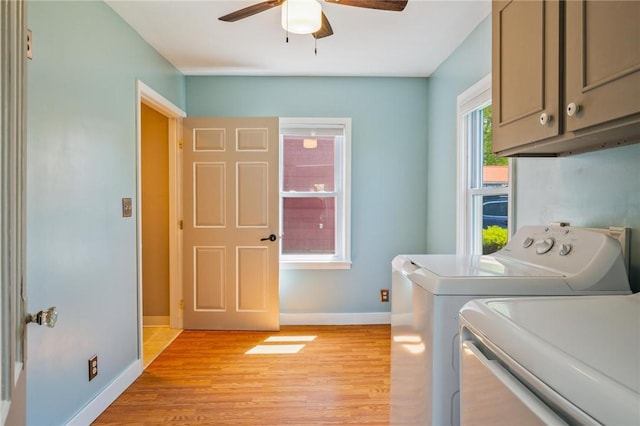 clothes washing area featuring cabinet space, separate washer and dryer, ceiling fan, baseboards, and light wood-style flooring