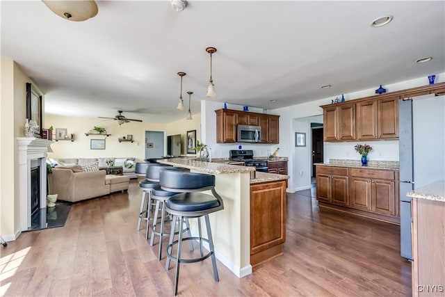 210 Funnycide Dr, Hounsfield, NY 13685 - kitchen with appliances with stainless steel finishes, open floor plan, a peninsula, dark wood-style floors, and recessed lighting
