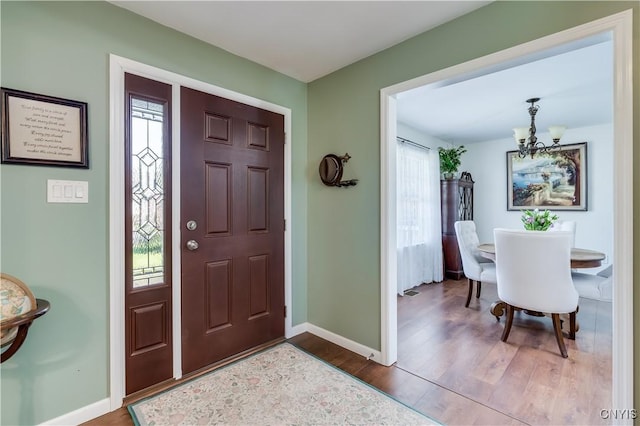 210 Funnycide Dr, Hounsfield, NY 13685 - foyer featuring a chandelier, wood finished floors, and baseboards