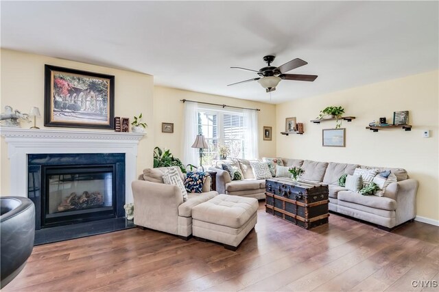 210 Funnycide Dr, Hounsfield, NY 13685 - living room with wood finished floors, a ceiling fan, and a glass covered fireplace