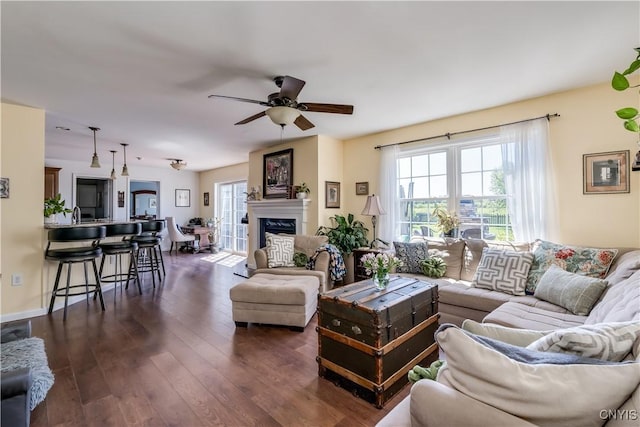 210 Funnycide Dr, Hounsfield, NY 13685 - living area with a ceiling fan, dark wood-type flooring, and a fireplace