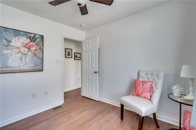 210 Funnycide Dr, Hounsfield, NY 13685 - living area with wood finished floors, a ceiling fan, and baseboards