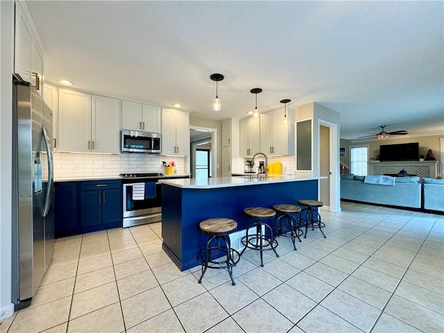 214 Fairfield Dr, Horseheads, NY 14845 - kitchen featuring stainless steel appliances, light tile patterned flooring, open floor plan, a peninsula, and backsplash