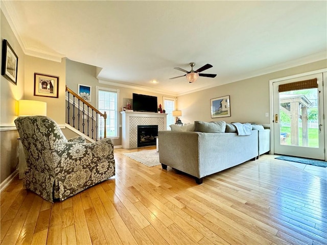 214 Fairfield Dr, Horseheads, NY 14845 - living room with ornamental molding, a fireplace, light wood-style flooring, a ceiling fan, and stairway