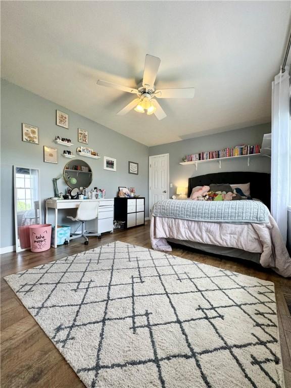 214 Fairfield Dr, Horseheads, NY 14845 - bedroom featuring an office area, lofted ceiling, wood finished floors, a ceiling fan, and baseboards