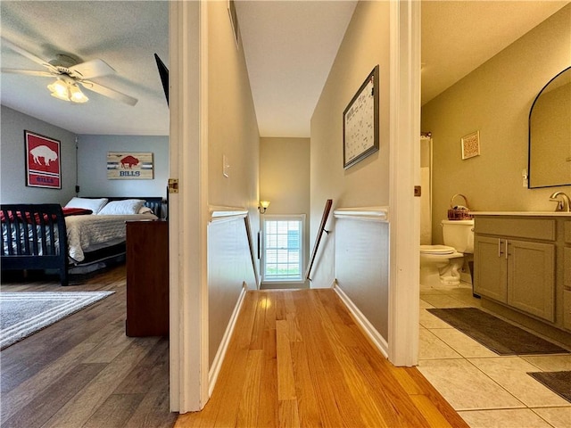 214 Fairfield Dr, Horseheads, NY 14845 - hall with an upstairs landing, light wood finished floors, and baseboards