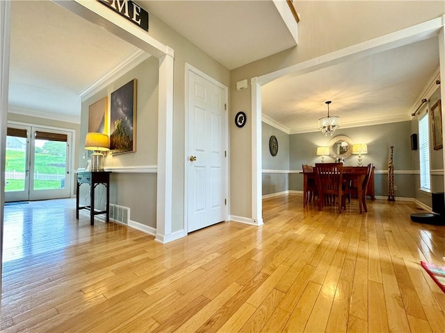 214 Fairfield Dr, Horseheads, NY 14845 - dining space featuring a chandelier, light wood finished floors, ornamental molding, baseboards, and arched walkways