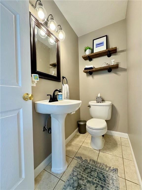 214 Fairfield Dr, Horseheads, NY 14845 - half bathroom featuring toilet, tile patterned floors, and baseboards