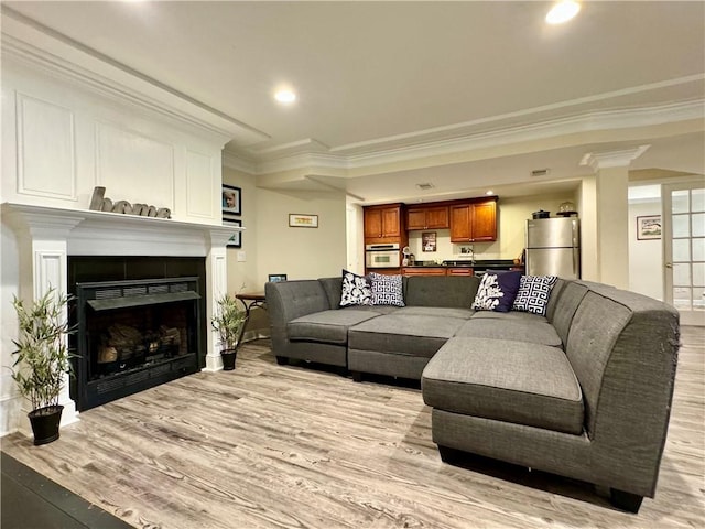 214 Fairfield Dr, Horseheads, NY 14845 - living area with light wood finished floors, crown molding, a fireplace, recessed lighting, and baseboards