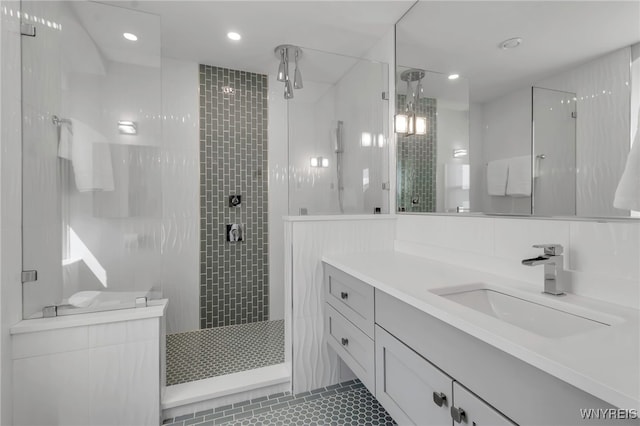bathroom featuring tiled shower, vanity, recessed lighting, and tile patterned floors