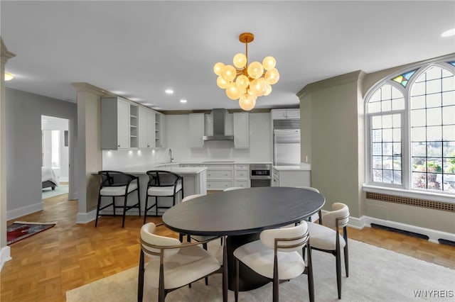 dining space featuring baseboards, a chandelier, and recessed lighting