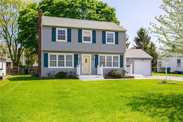 colonial home with a chimney, a garage, central AC unit, and concrete driveway