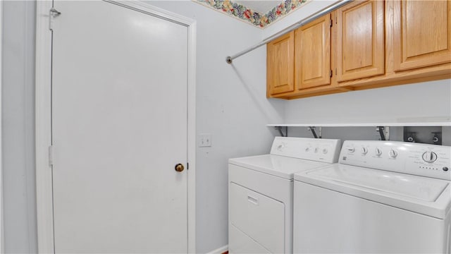 laundry area featuring independent washer and dryer and cabinet space