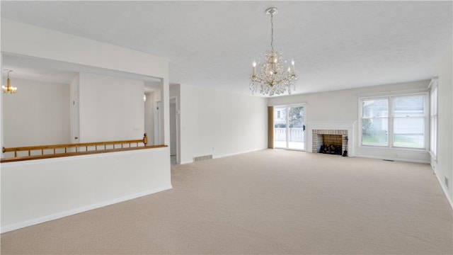 unfurnished living room featuring a chandelier, carpet flooring, baseboards, and a fireplace