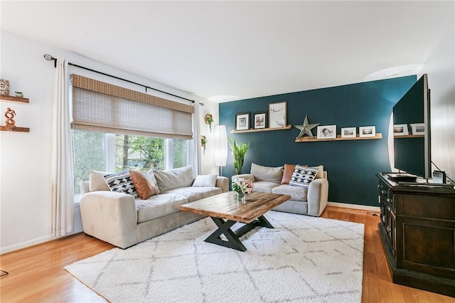 living area with wood finished floors and baseboards