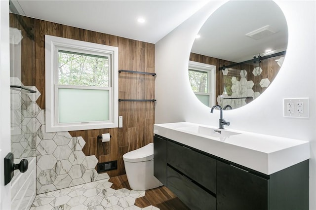 full bath with plenty of natural light, a shower, toilet, and vanity