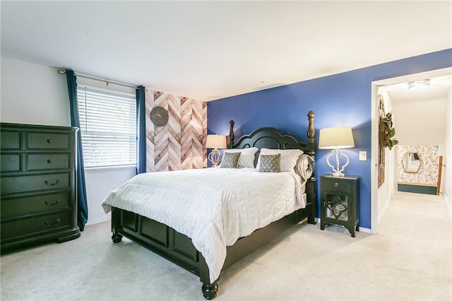 bedroom featuring light carpet and baseboards
