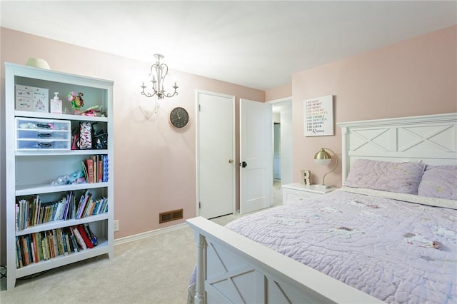 bedroom with light colored carpet, a chandelier, and baseboards