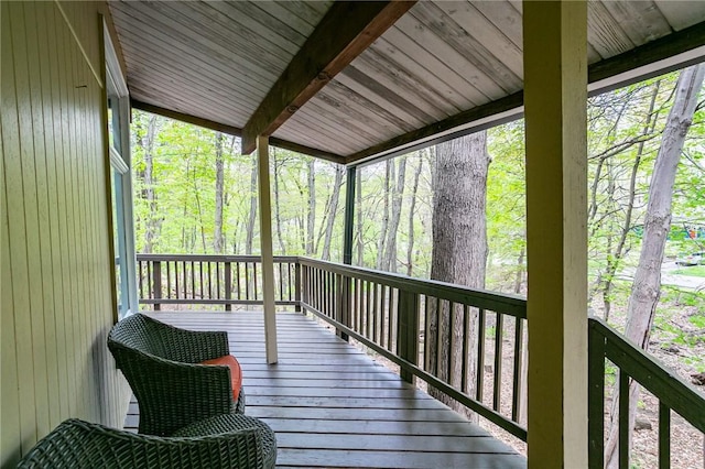 wooden deck featuring a forest view