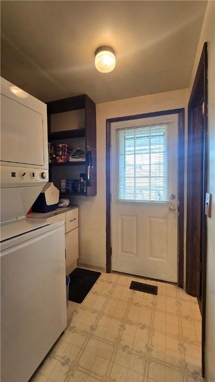 612 Reynolds St, Elmira-City, NY 14904 - laundry area with stacked washing machine and dryer and light floors