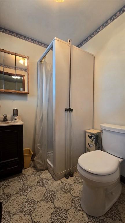 612 Reynolds St, Elmira-City, NY 14904 - bathroom with a shower stall, toilet, and vanity