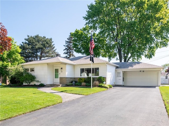 ranch-style house with an attached garage, a front lawn, and driveway