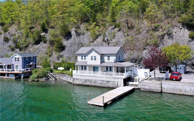 dock featuring a water view and a forest view