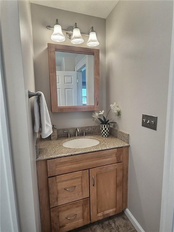 bathroom with vanity and baseboards