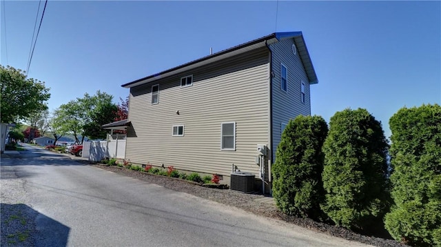 view of side of property with central air condition unit
