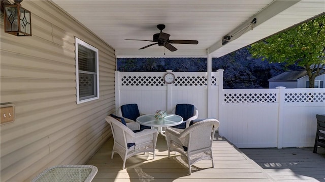 deck featuring ceiling fan, outdoor dining space, and fence
