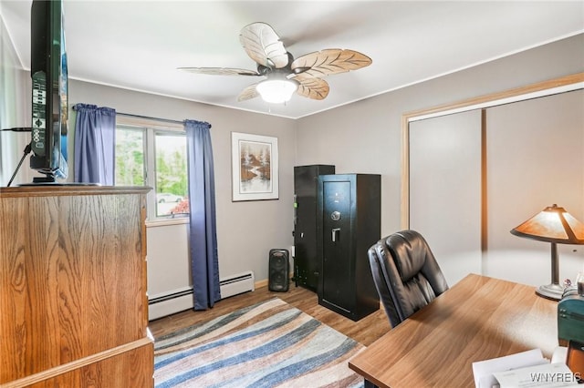 office with wood finished floors, a ceiling fan, and a baseboard heating unit