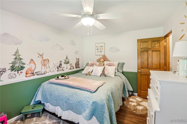 bedroom featuring wood finished floors, a ceiling fan, and baseboards