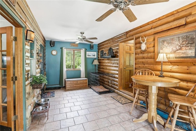 interior space with ceiling fan, rustic walls, and tile patterned floors